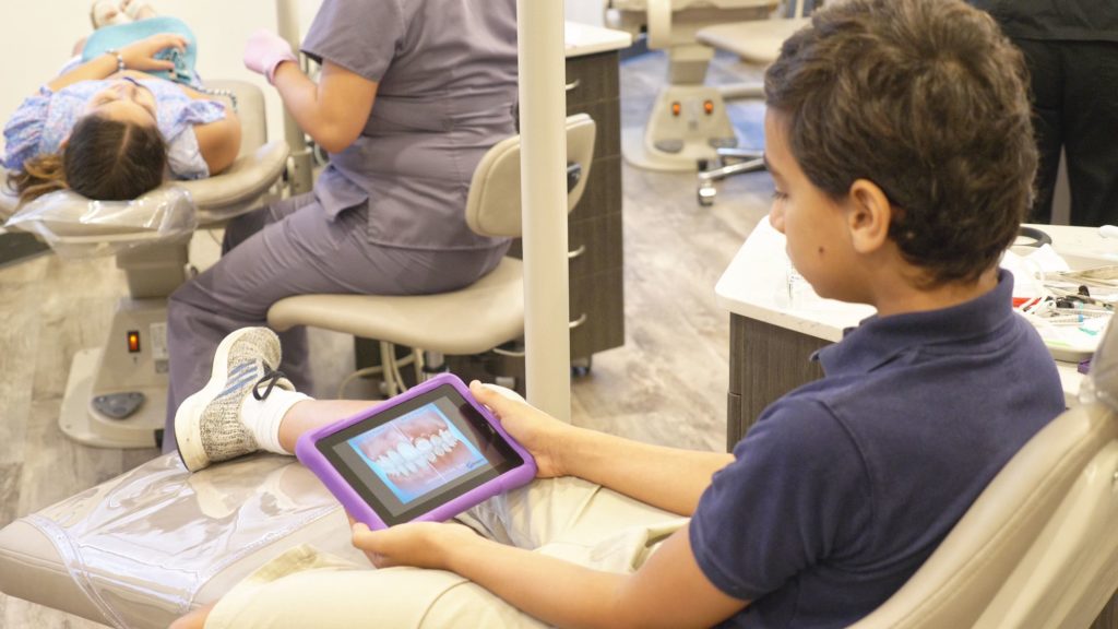 Young patient looking at dental scans on an IPad
