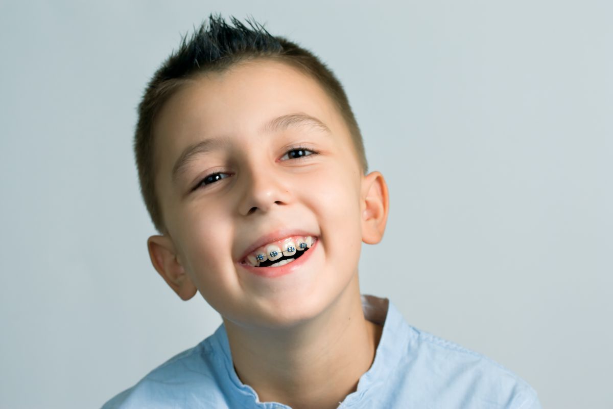 Why Your Child Should See Boy smiling An Orthodontist By Age 7
